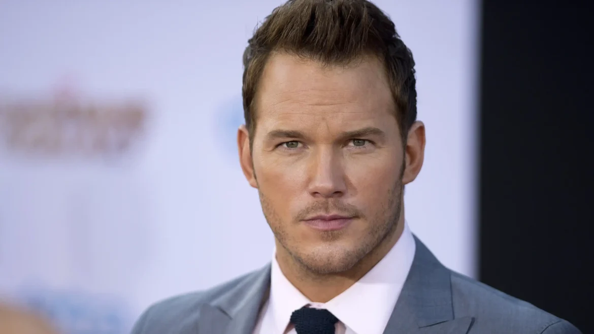 Close-up portrait of actor Chris Pratt in a grey suit and pink shirt at a red carpet event, high-resolution 4K celebrity wallpaper.