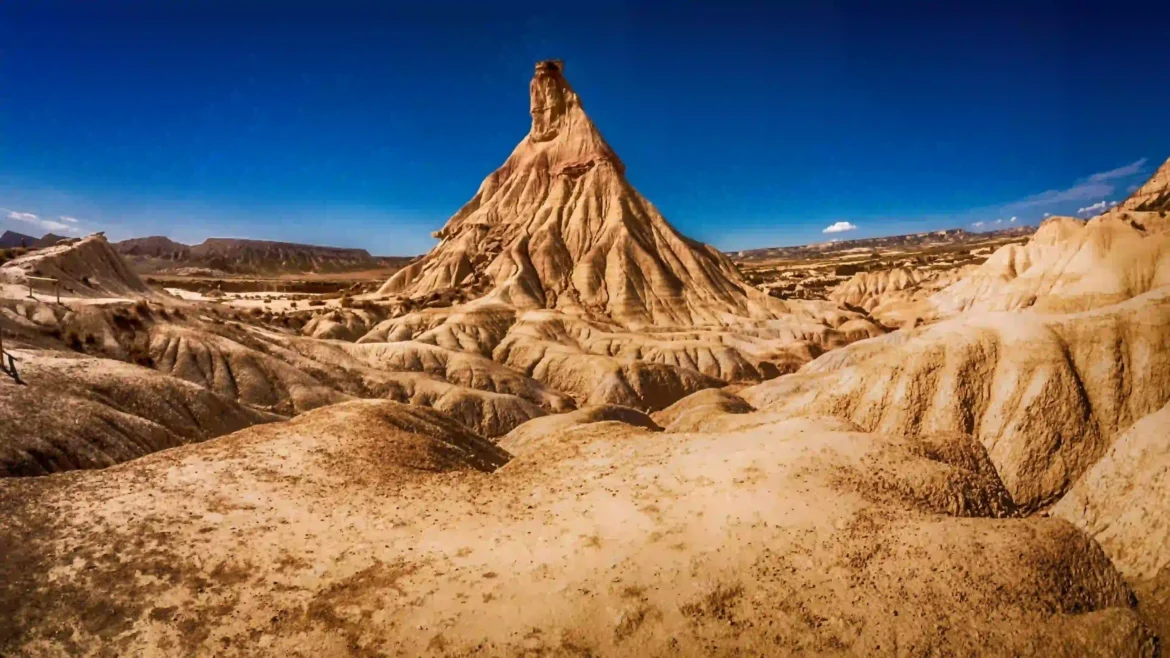 Desert mountain wallpaper 4K with rocky badlands landscape under blue sky