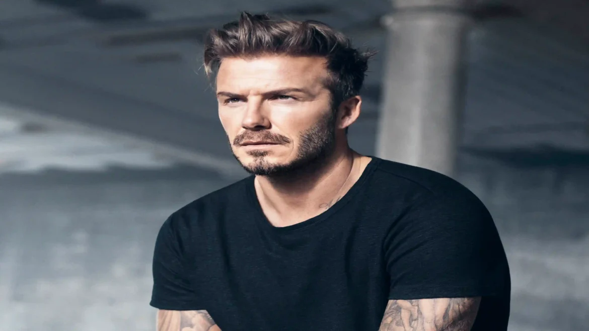 David Beckham portrait wallpaper featuring the football legend in a stylish black shirt with a modern cinematic background