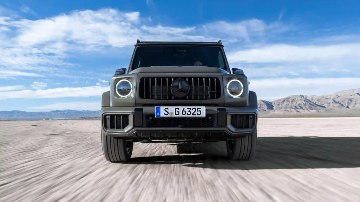 Mercedes-AMG G63 luxury SUV driving across a desert landscape with mountains and blue sky in a cinematic automotive wallpaper