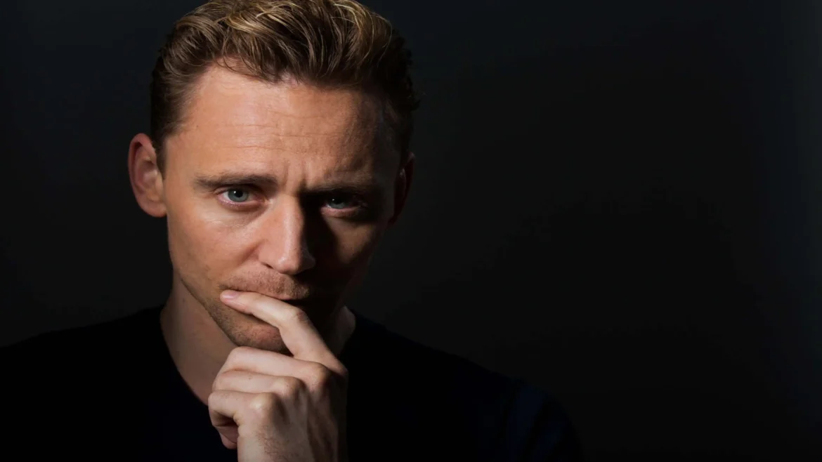 Tom Hiddleston portrait with dramatic lighting and black background 4K wallpaper