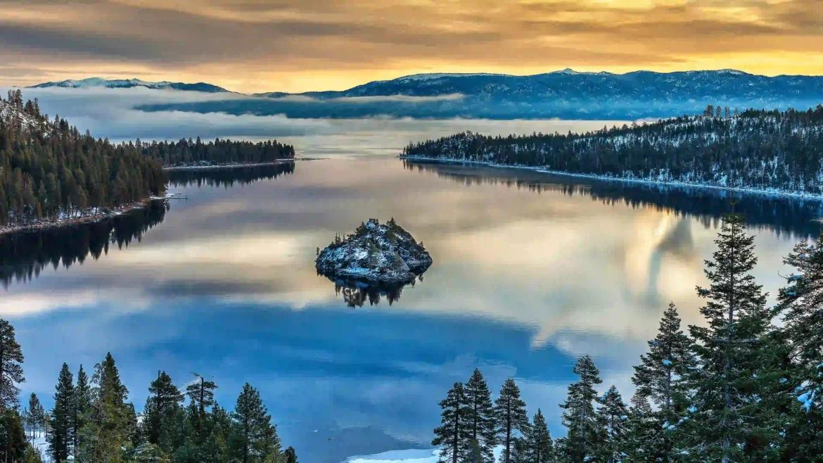 Emerald Bay Lake Tahoe at sunrise with crystal-clear reflections, snowy mountains, and pine forests in Ultra HD 4K wallpaper