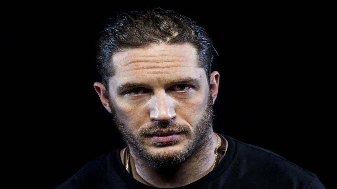 Close-up portrait of Tom Hardy with an intense expression against a black background in an Ultra HD 4K wallpaper