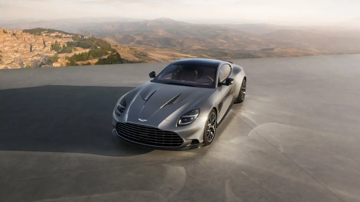 2026 Aston Martin Vanquish in silver parked on a scenic terrace overlooking mountains and water in a stunning 4K luxury car wallpaper