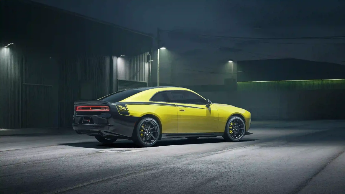 Yellow and black 2027 Dodge Charger Super Bee muscle car parked in front of an industrial building at night in a 4K car wallpaper