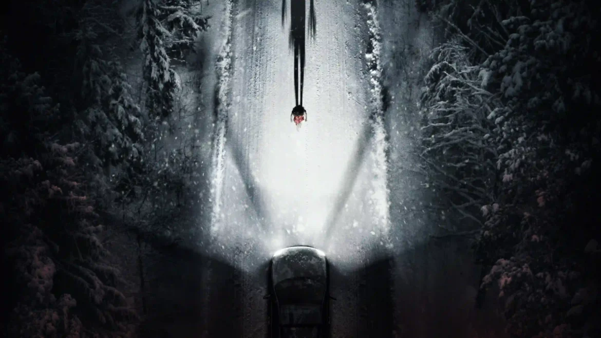 Top-down view of a car on a snowy forest road at night with headlights illuminating a tall shadow figure in a 4K Resident Evil movie poster wallpaper