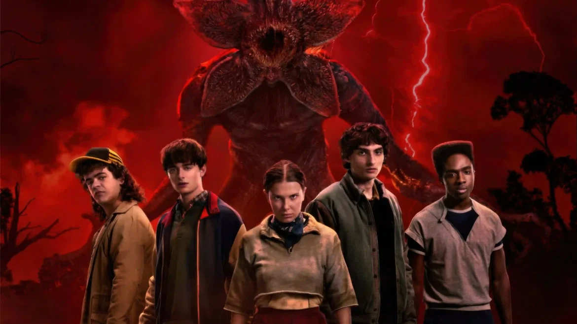 Promo key art of Eleven, Mike, Will, Dustin, and Lucas standing together with a giant Demogorgon behind them under a red lightning sky in a 4K Stranger Things wallpaper