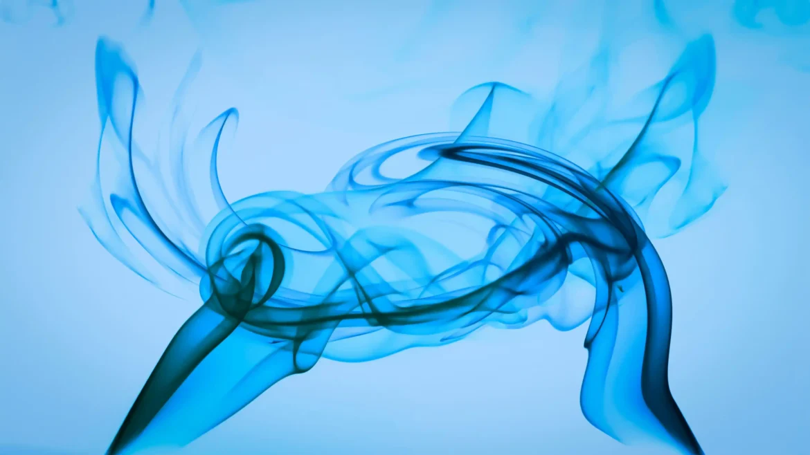 Macro photography of fluid blue smoke wisps and swirls gracefully curling against a bright blue background in a 4K wallpaper